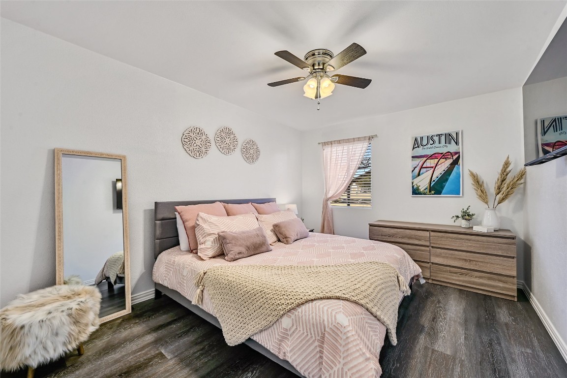 115 Comanche Drive Point Venture, TX 78645 - Photo 16 of 31 a bedroom with a bed and a chandelier