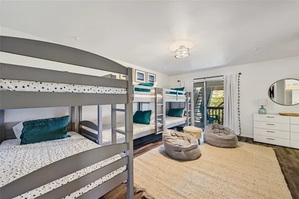 a bedroom with a bed and a wooden floor