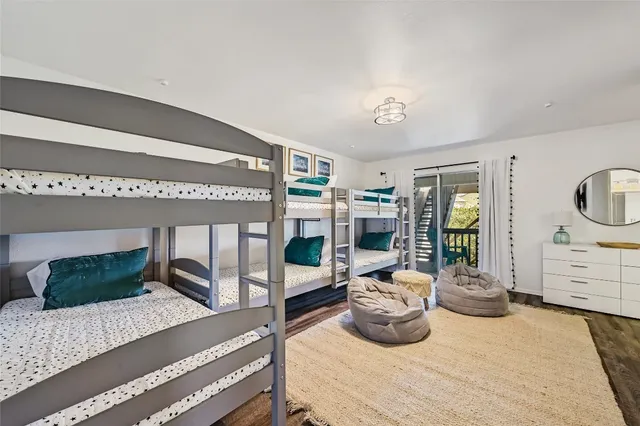 a bedroom with a bed and a wooden floor