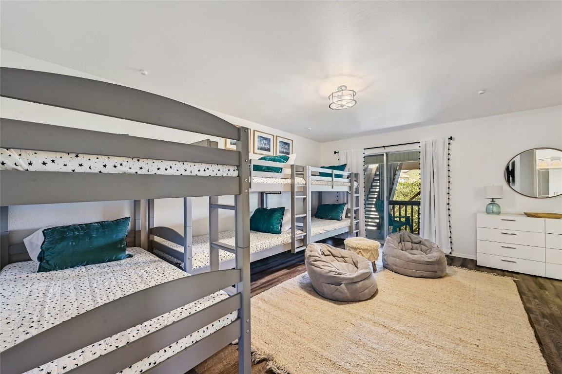 115 Comanche Drive Point Venture, TX 78645 - Photo 18 of 31 a bedroom with furniture and a large window