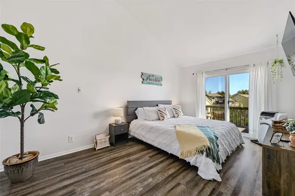 a bedroom with a bed and a lamp