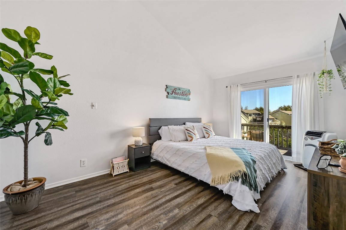 115 Comanche Drive Point Venture, TX 78645 - Photo 22 of 31 a bedroom with a bed table flowerpot and a window