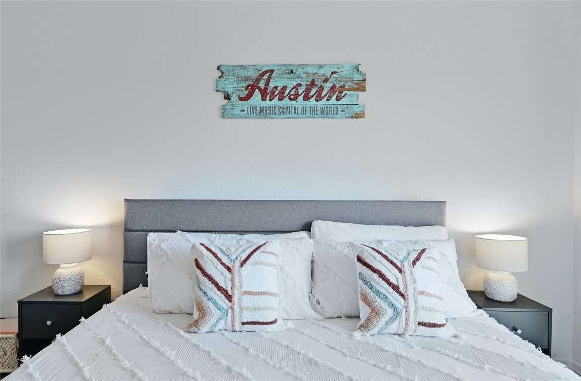 115 Comanche Drive Point Venture, TX 78645 - Photo 23 of 31 a bedroom with a bed and a lamp