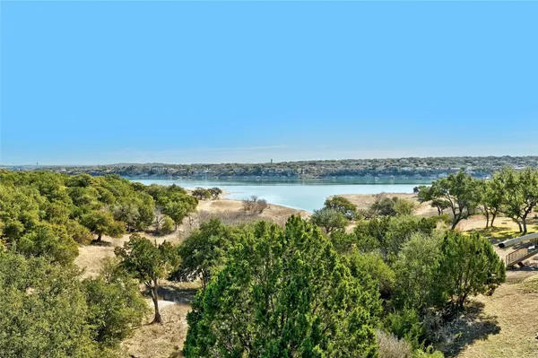 a view of a lake with houses in the back