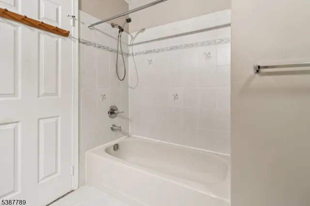 a bathroom with a shower and a bath tub