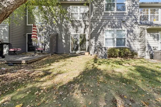 a view of a yard with plants and trees