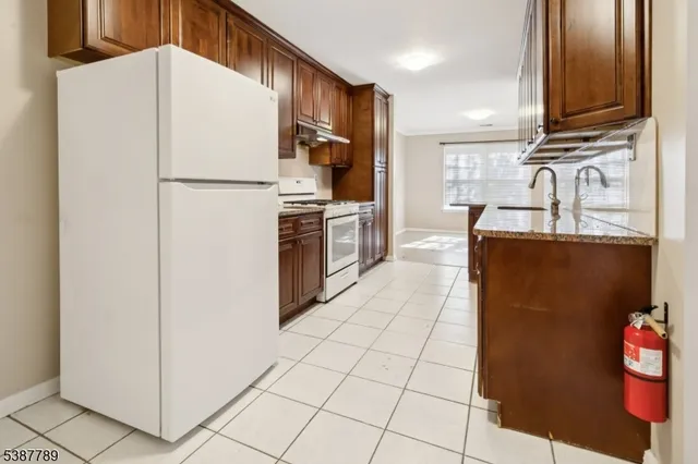 a kitchen with stainless steel appliances a refrigerator sink and microwave