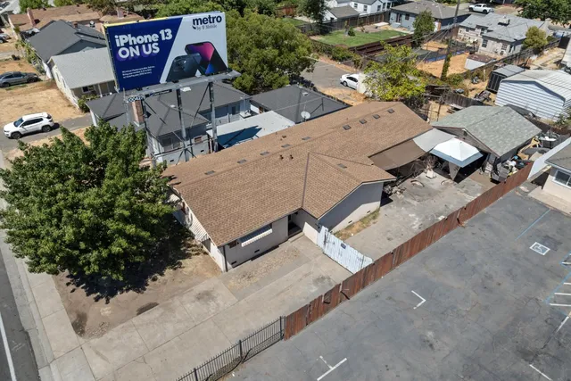 an aerial view of multiple houses with yard