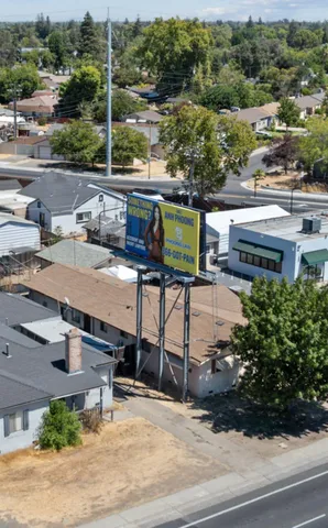 an aerial view of a house with garden space and street view