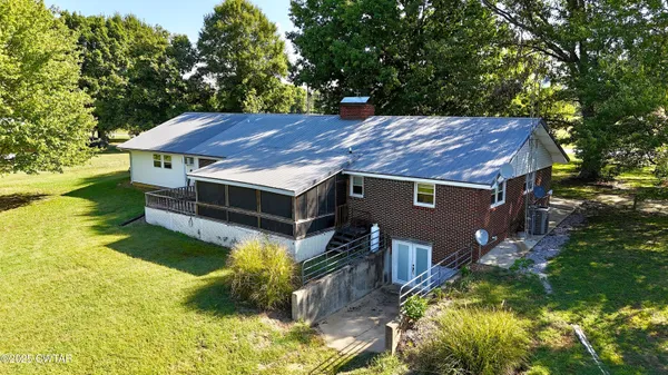 a aerial view of a house with a yard table and chairs