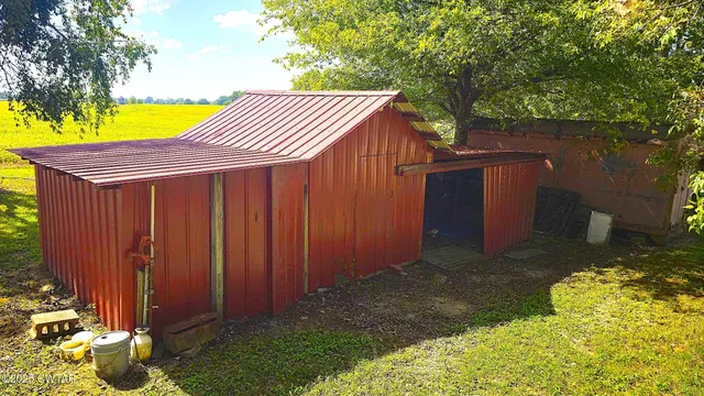 an empty room with wooden floor and window