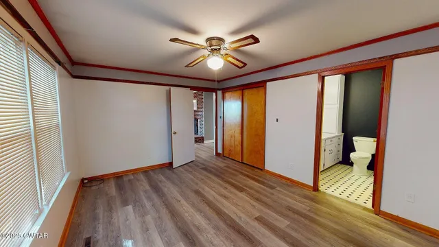 a view of a room with wooden floor