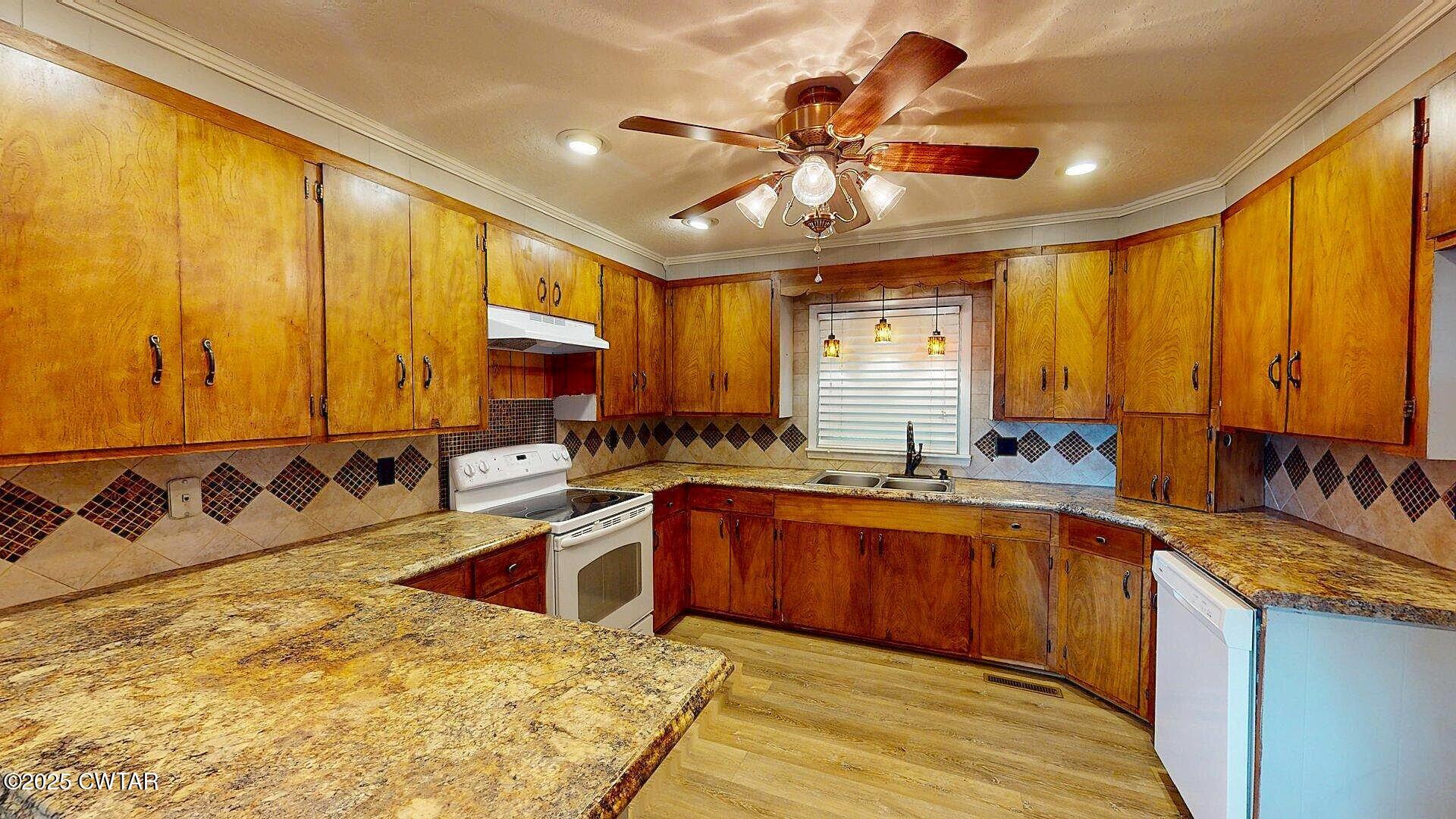 67 Ode Reed Road Dyer, TN 38330 - Photo 3 of 24 a kitchen with stainless steel appliances granite countertop sink stove and large window
