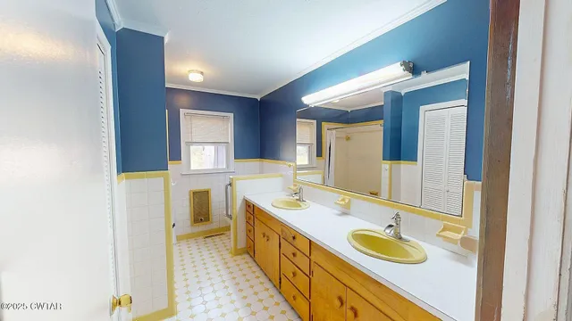 a bathroom with a double vanity sink and a mirror