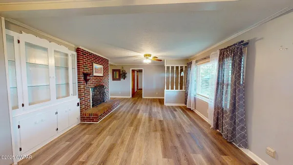 a view of hallway with wooden floor and windows