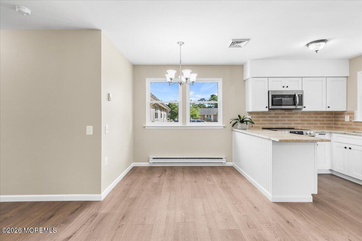 16 D Spring Street, Unit 50 Whiting, NJ 08759 - Photo 15 of 28 a view of kitchen with microwave a stove and wooden floor
