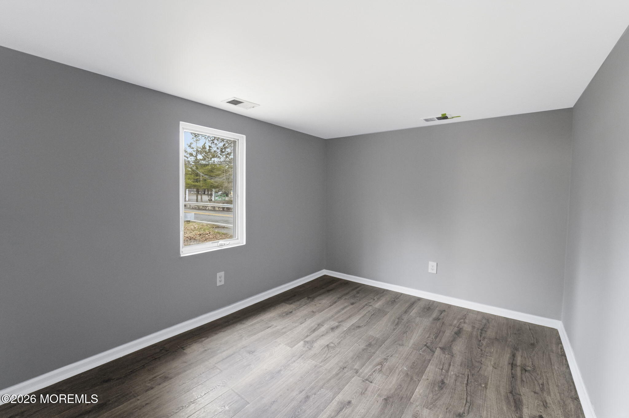 466 Stagecoach Road Millstone Township, NJ 08510 - Photo 11 of 16 an empty room with wooden floor and windows