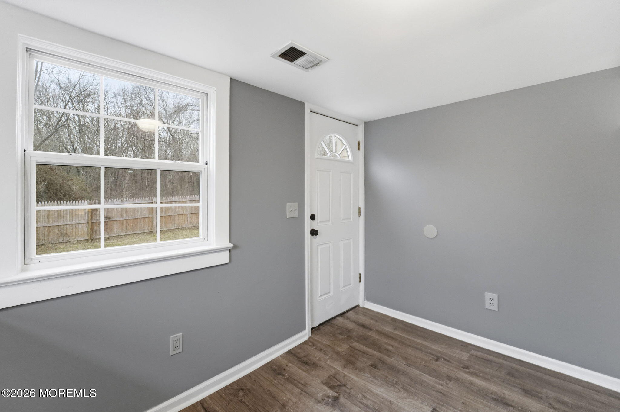 466 Stagecoach Road Millstone Township, NJ 08510 - Photo 12 of 16 a view of an empty room with wooden floor and a window