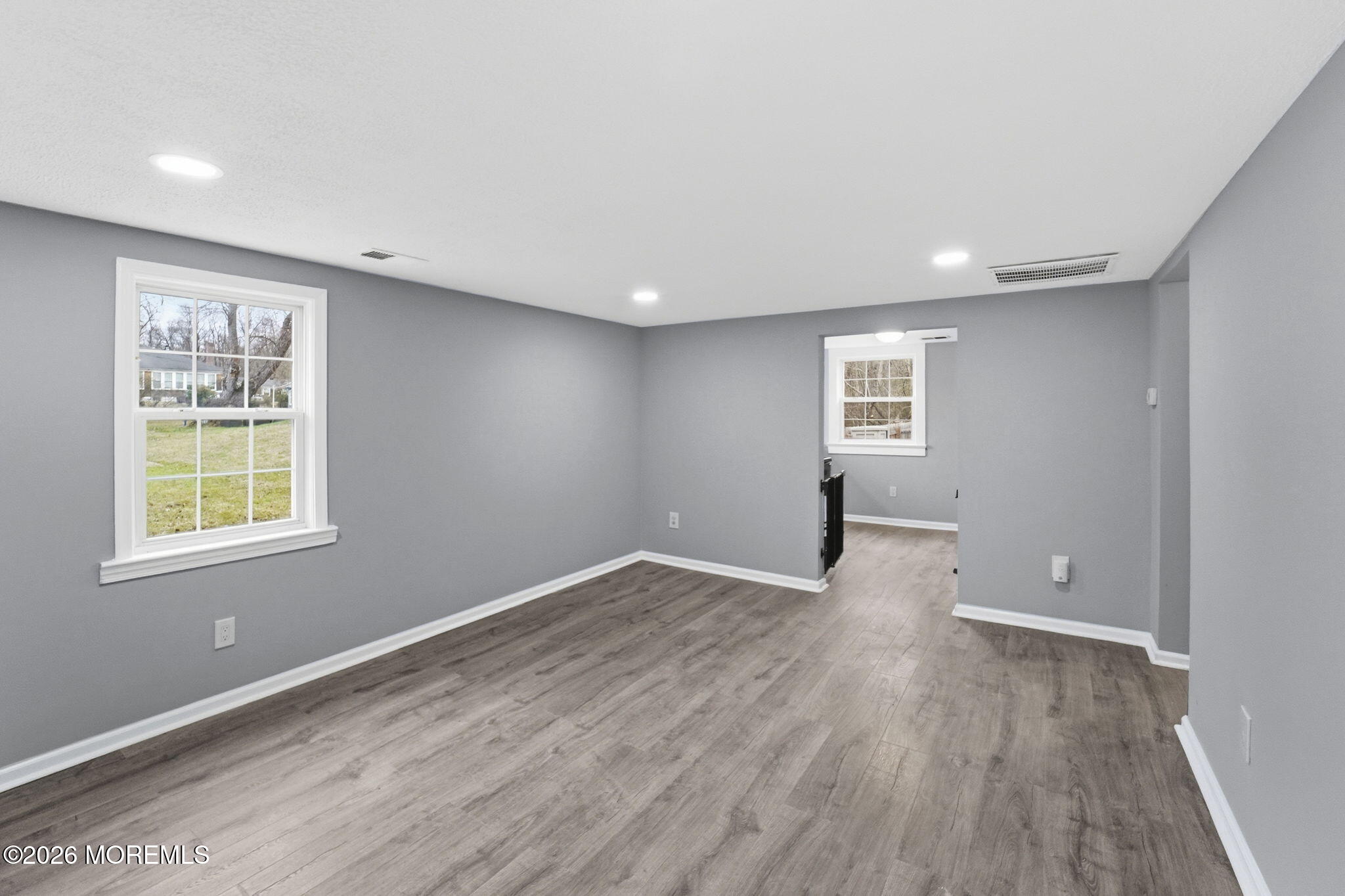 466 Stagecoach Road Millstone Township, NJ 08510 - Photo 8 of 16 an empty room with wooden floor and windows