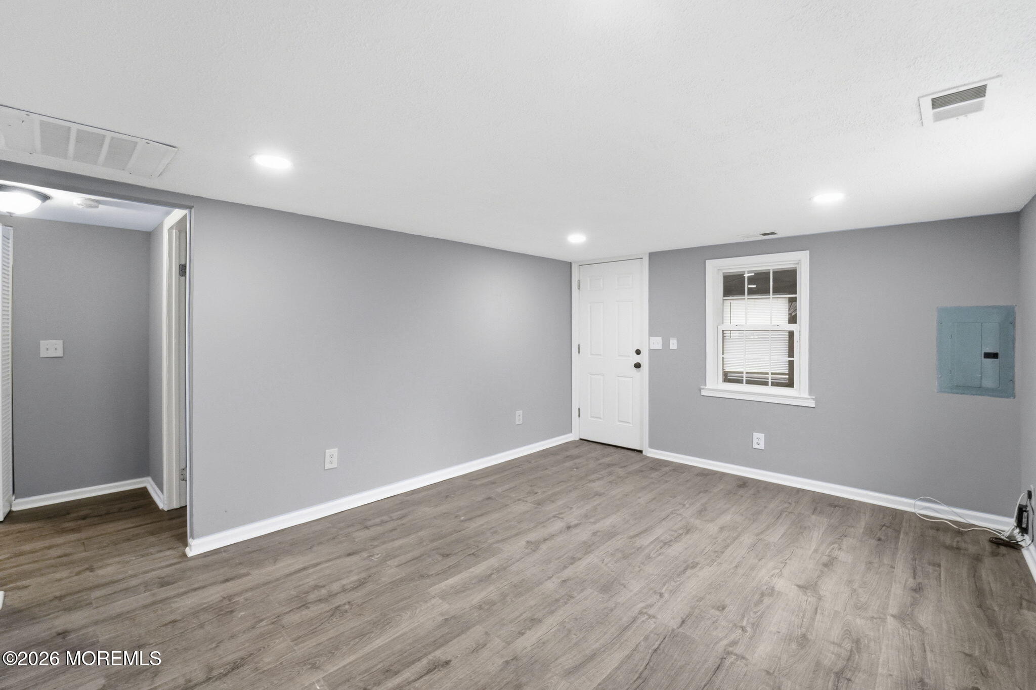 466 Stagecoach Road Millstone Township, NJ 08510 - Photo 9 of 16 a view of an empty room with wooden floor and a window