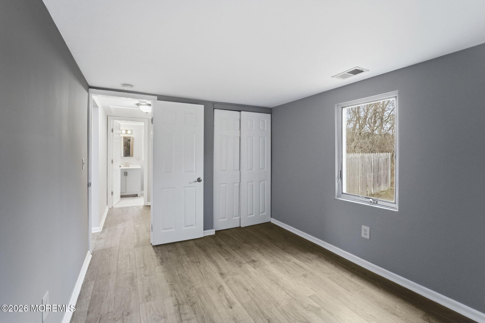 466 Stagecoach Road Millstone Township, NJ 08510 - Photo 10 of 16 a view of an empty room with wooden floor and a window