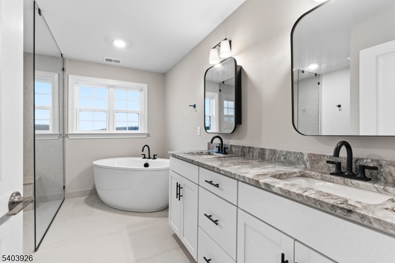 105 Junction Road Hampton, NJ 08827 - Photo 22 of 40 a bathroom with double sink and a mirror