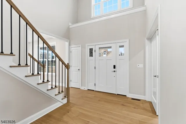 a view of an entryway with wooden floor