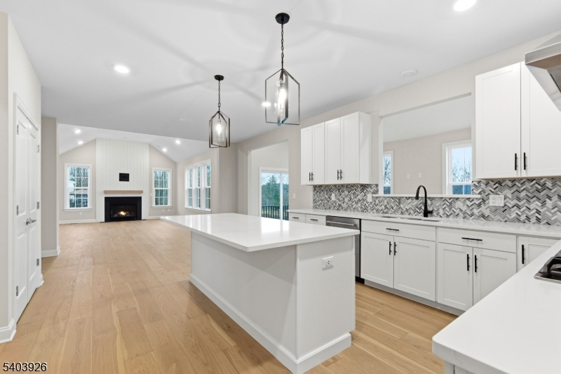 105 Junction Road Hampton, NJ 08827 - Photo 9 of 40 a large kitchen with granite countertop a stove oven a sink dishwasher and white cabinets with wooden floor