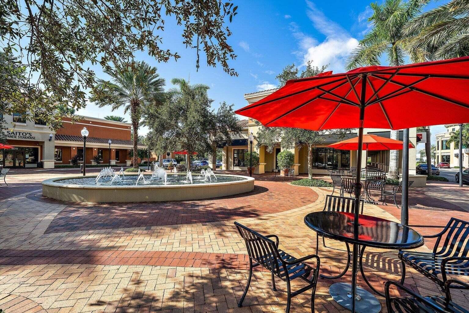 a view of a swimming pool with a table and chairs under an umbrella
