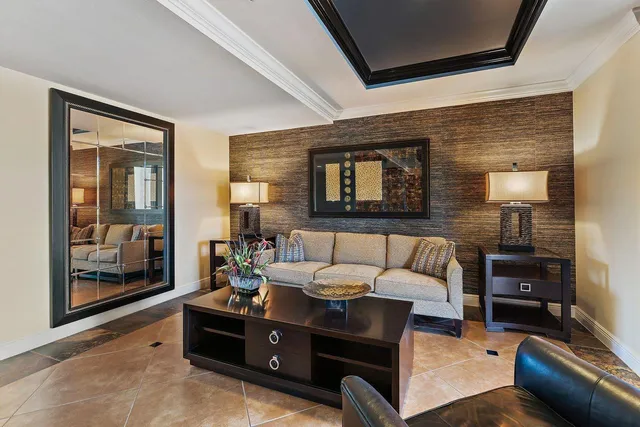 a living room with furniture and a painting on the wall