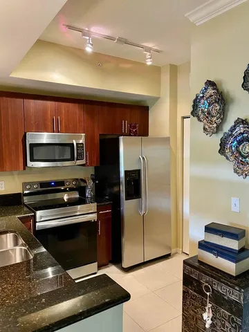 a kitchen with stainless steel appliances a stove a microwave and a refrigerator