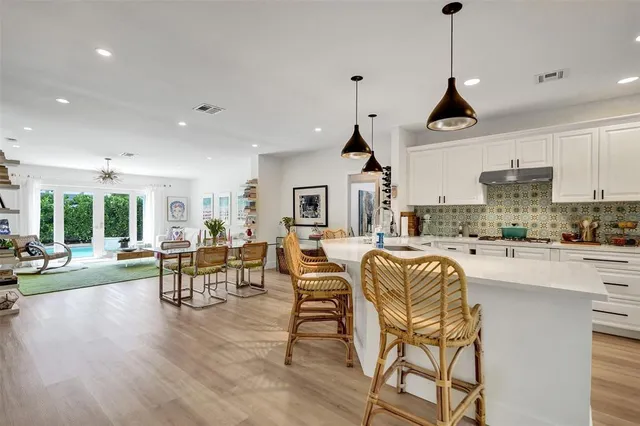 a living room with furniture hard wood floor and a flat screen tv