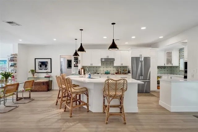a bathroom with a double vanity sink mirror and bathtub