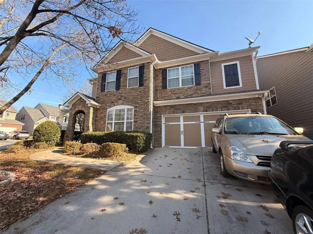 a front view of a house with parking space