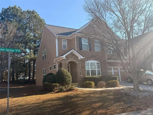 a front view of a house with a yard