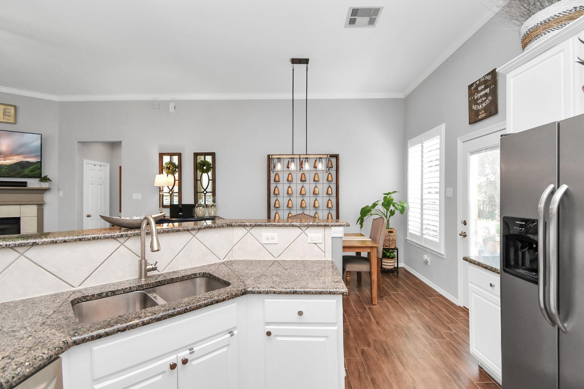 8624 Sunset Loch Drive Spring, TX 77379 - Photo 16 of 44 a kitchen with stainless steel appliances granite countertop a sink a stove and refrigerator