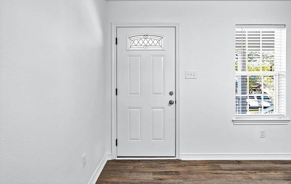 406 East Elm Street Denison, TX 75021 - Photo 16 of 21 a view of an empty room with wooden floor and a window