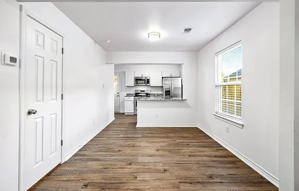 a view of a kitchen from a hallway