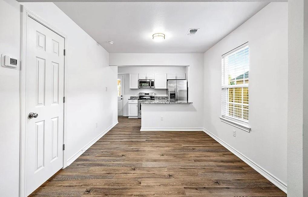 406 East Elm Street Denison, TX 75021 - Photo 8 of 21 a view of a kitchen from a hallway