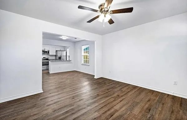 wooden floor in an empty room with a window