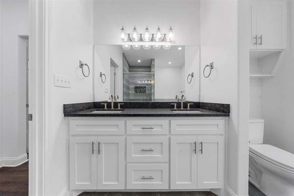 1698 Rogers Hill Road Waco, TX 76705 - Photo 17 of 40 Full bath with double vanity, a stall shower, toilet, baseboards, and wood finished floors
