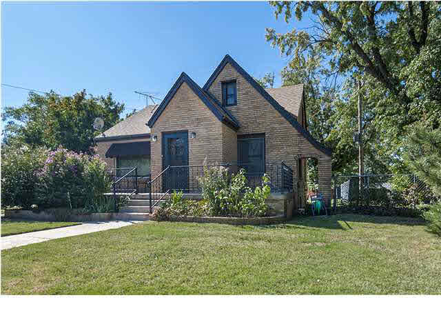 Let's seewhere shall we begin? How about we greet you with a groomed lawn and landscape, Tudor-style architecture, a massive front porch, and a grand sense of arrival? Intrigued? It only gets better from here, so come on in