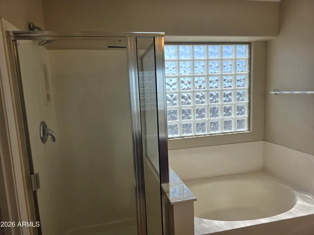 a bathroom with a bathtub and a shower