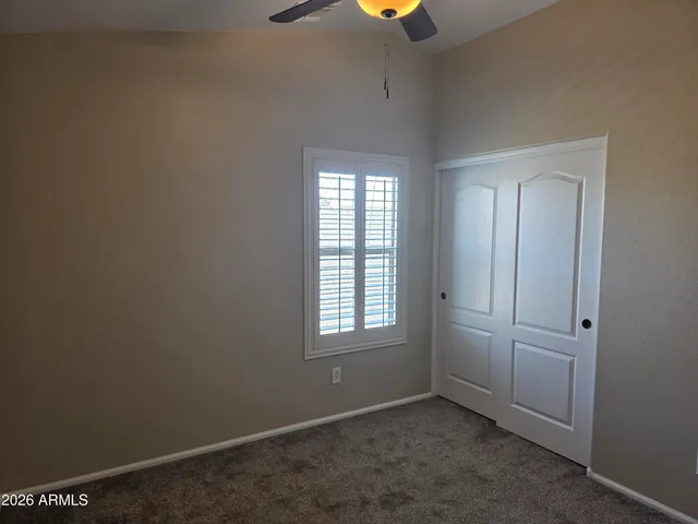 an empty room with windows and closet
