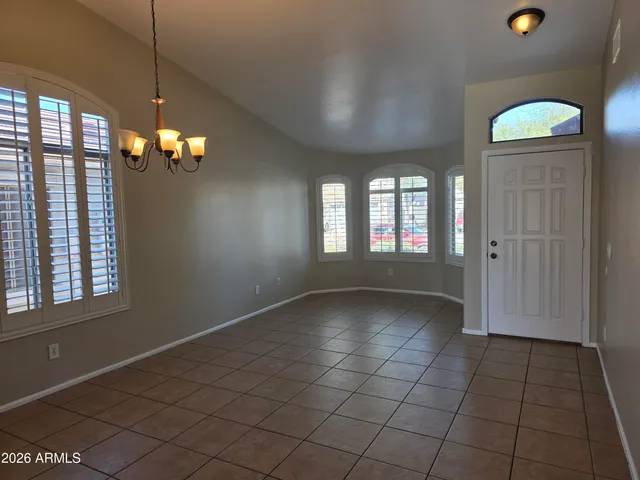 a view of a room with window and chandelier fan