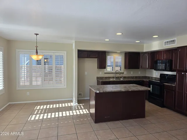 a kitchen with stainless steel appliances granite countertop a stove sink and cabinets