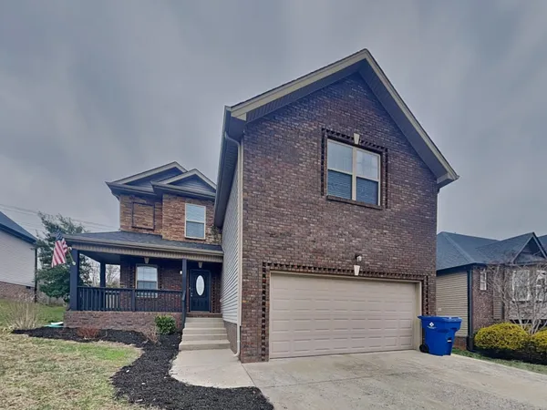 a front view of a house with a yard and garage