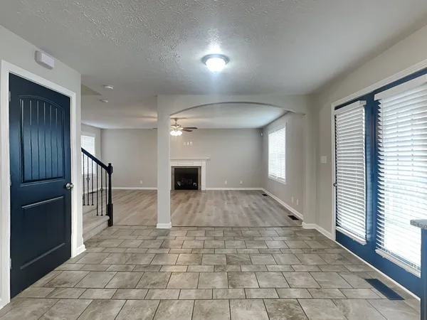 a view of hallway with stairs and a window