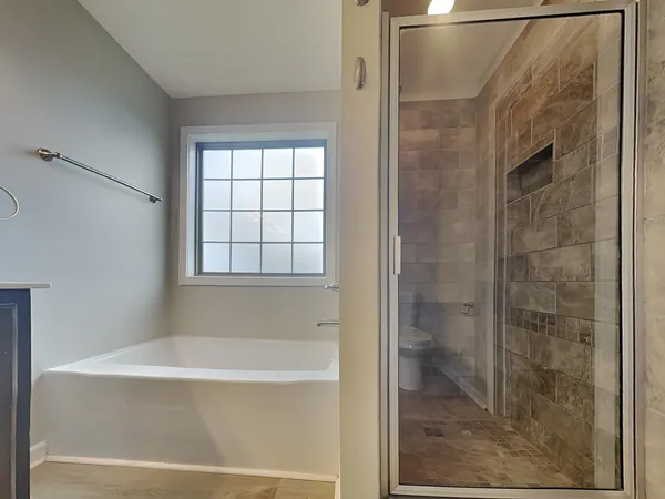 a bathroom with a bathtub and shower
