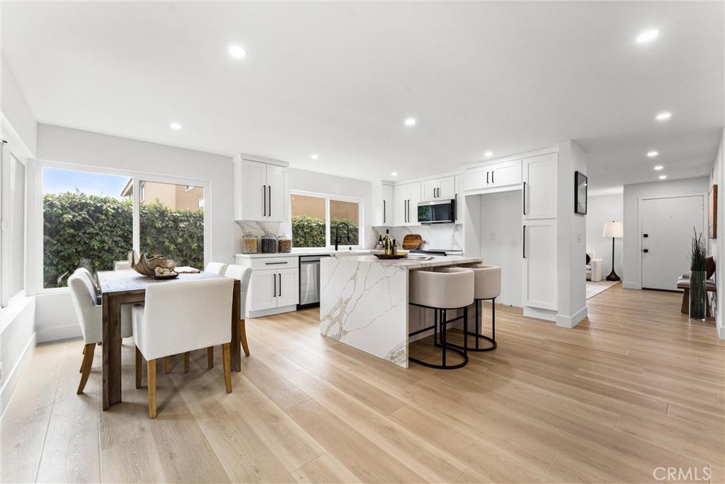 3621 Myrtle Street Irvine, CA 92606 - Photo 12 of 40 a living room with furniture and a dining table with kitchen view